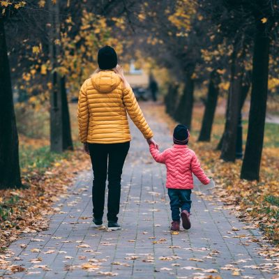 Mother and daughter walking in autumn